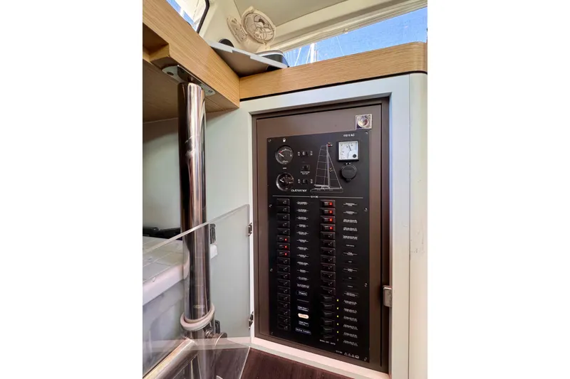Slide: The Image of Electrical panel inside a 2017 Outremer 51 catamaran, featuring various switches and gauges. - 70