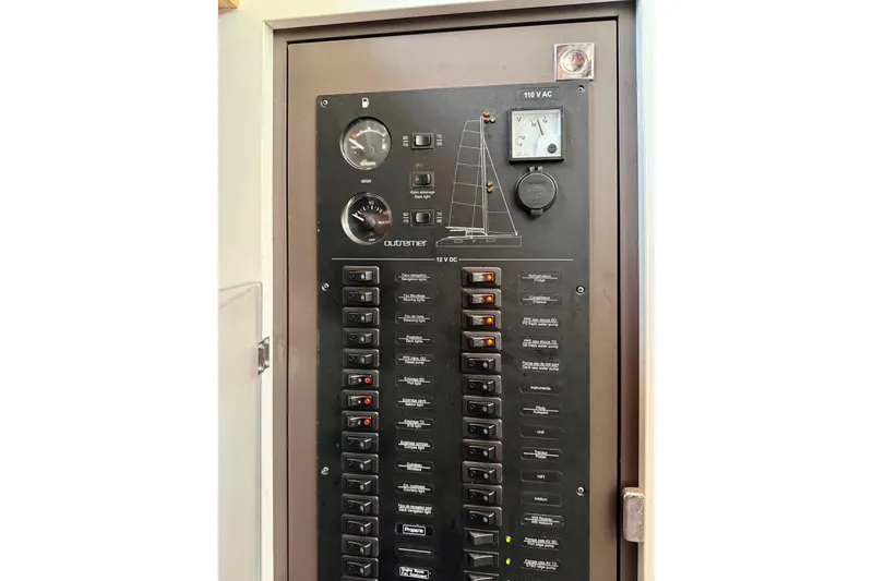 Slide: The Image of Electrical panel of a 2017 Outremer 51 catamaran with various switches and gauges. - 71