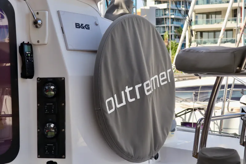 Slide: The Image of 2017 Outremer 51 yacht helm with cover, B&G equipment, marina background. - 86