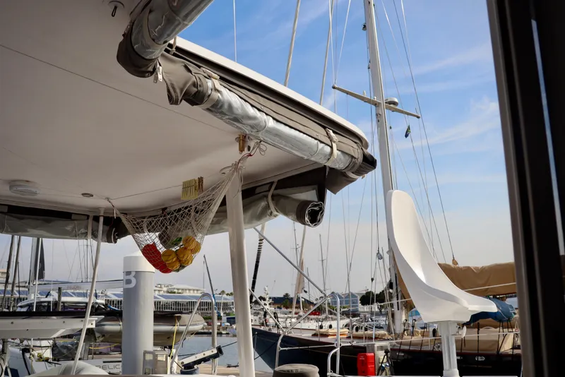 Slide: The Image of Outremer 51 catamaran, 2017 model, docked at marina with visible rigging and seating. - 94
