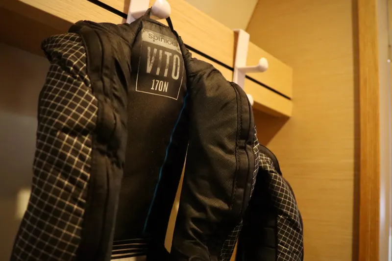 Slide: The Image of Life jackets hanging inside a 2017 Outremer 51 catamaran cabin. - 96