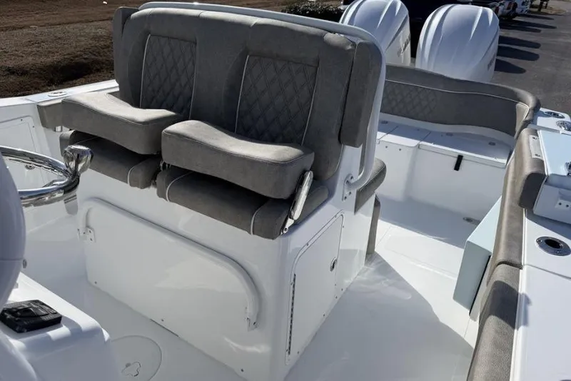 Slide: The Image of 2026 Sea Hunt Ultra 275 SE boat interior with cushioned seating and steering wheel. - 11