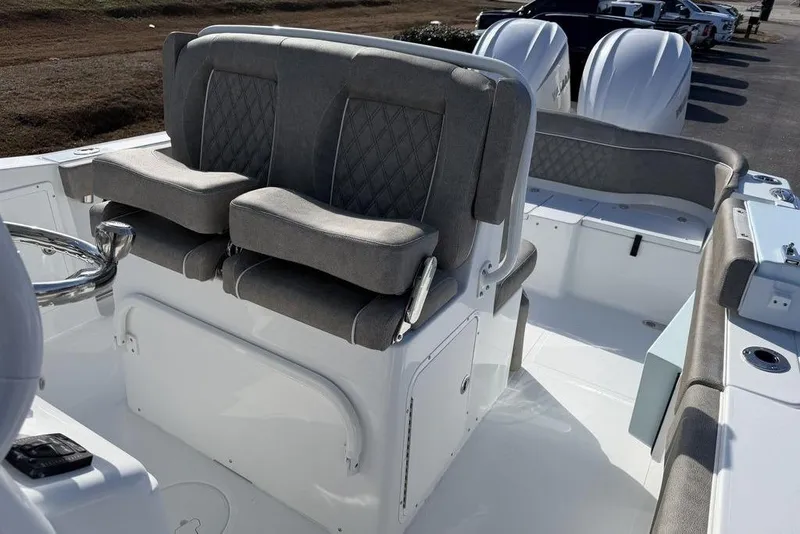 Slide: The Image of 2026 Sea Hunt Ultra 275 SE boat interior with dual seats and steering wheel. - 16