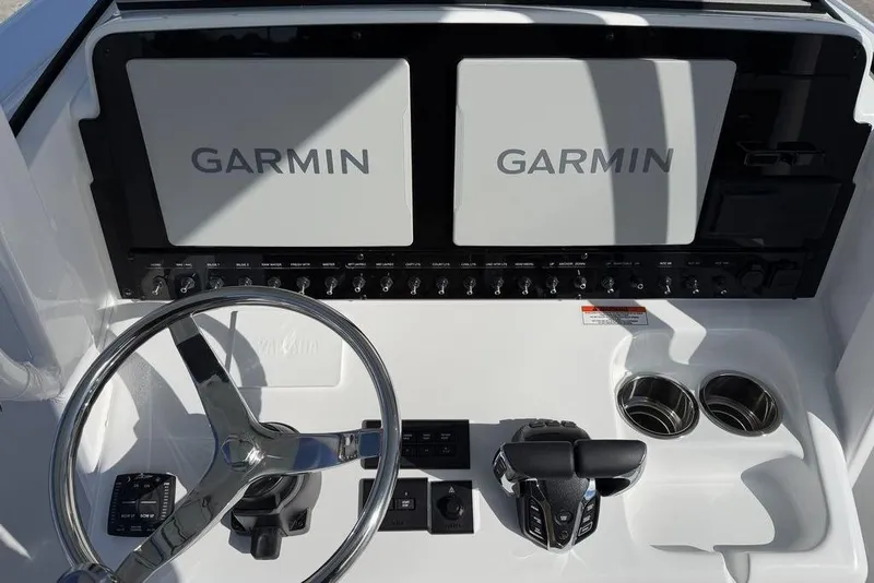 Slide: The Image of 2026 Sea Hunt Ultra 275 SE dashboard with Garmin displays and steering wheel. - 18