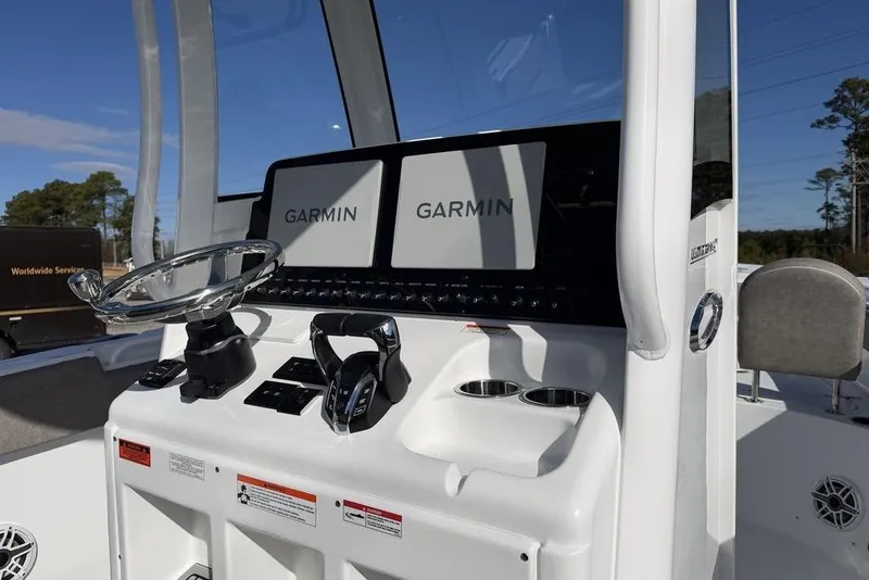 Slide: The Image of 2026 Sea Hunt Ultra 275 SE boat dashboard with Garmin navigation displays. - 20