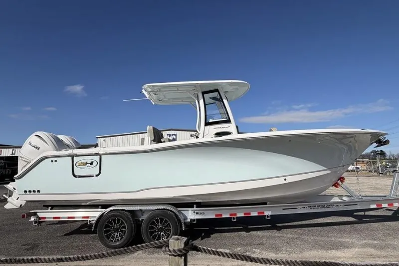 Slide: The Image of 2026 Sea Hunt Ultra 275 SE boat on trailer under clear blue sky. - 4