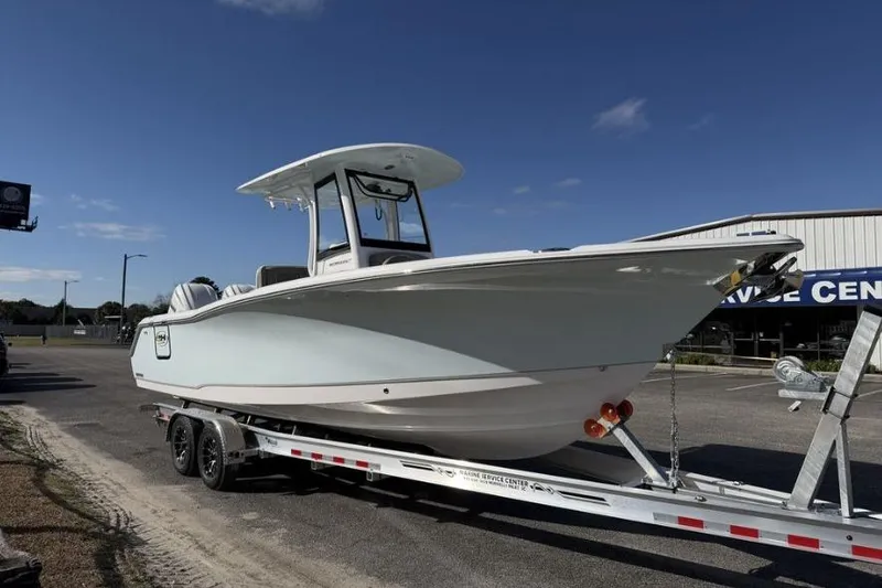 Slide: The Image of 2026 Sea Hunt Ultra 275 SE boat on trailer, parked outdoors under clear sky. - 5