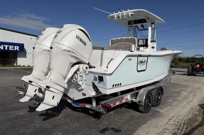 Slide: The Image of 2026 Sea Hunt Ultra 275 SE boat with dual Yamaha engines on a trailer. - 6