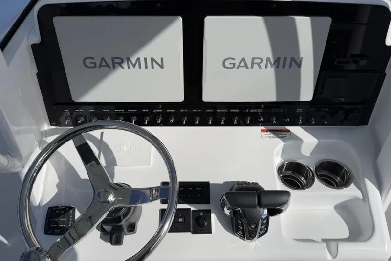 Slide: The Image of 2026 Sea Hunt Ultra 275 SE dashboard with dual Garmin displays and steering wheel. - 8