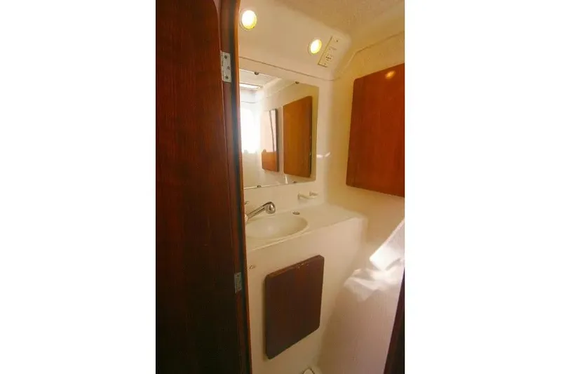 Slide: The Image of Bathroom interior of 1992 Privilege 482 yacht with sink and wooden cabinets. - 10