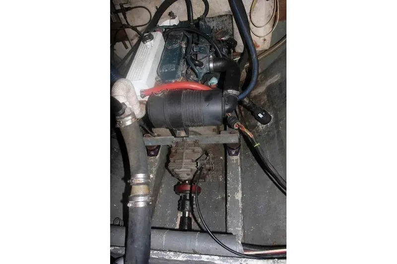 Slide: The Image of Engine compartment of a 1992 Privilege 482 boat, showing mechanical components and hoses. - 12