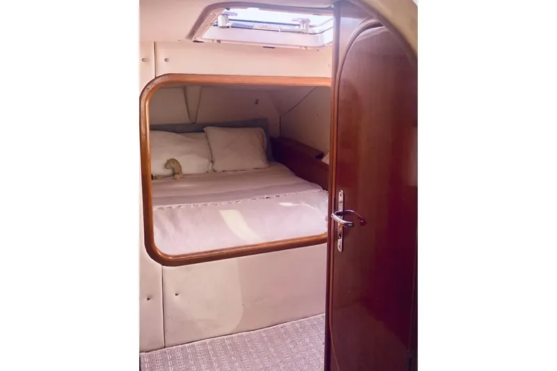 Slide: The Image of Cozy cabin interior of 1992 Privilege 482 yacht with wooden door and bedding. - 23
