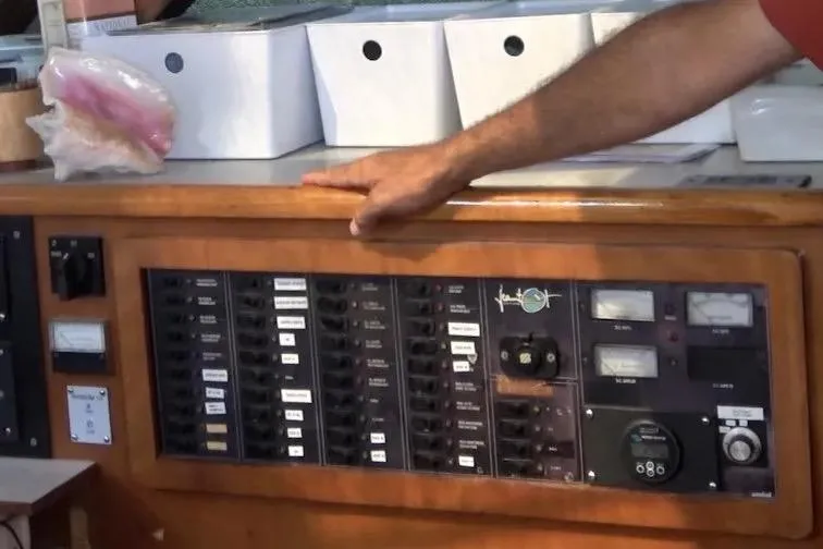 Slide: The Image of Control panel of a 1992 Privilege 482 yacht with various switches and gauges. - 25