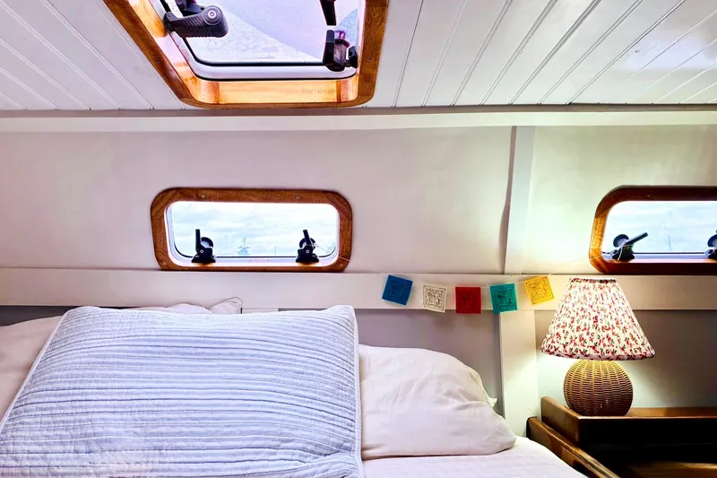Slide: The Image of Cozy cabin interior of 1992 Privilege 482 yacht with decorative lamp and porthole windows. - 32