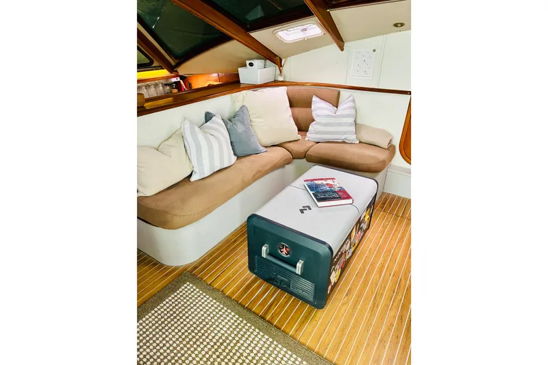 Slide: The Image of Cozy interior of 1992 Privilege 482 yacht with cushioned seating and wooden flooring. - 35