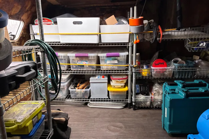 Slide: The Image of Organized storage shelves with various tools and containers on a Privilege 482, 1992 model. - 37