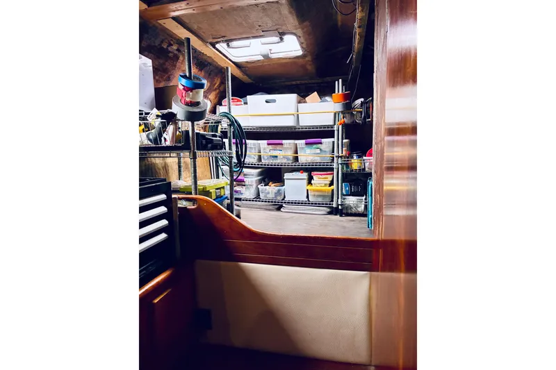 Slide: The Image of Storage area inside 1992 Privilege 482 boat with organized shelves and supplies. - 38