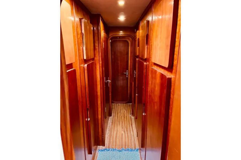 Slide: The Image of Narrow wooden hallway inside 1992 Privilege 482 yacht, featuring sleek cabinetry and lighting. - 39