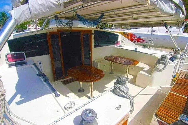 Slide: The Image of Cockpit of 1992 Privilege 482 yacht with wooden tables and seating area. - 4