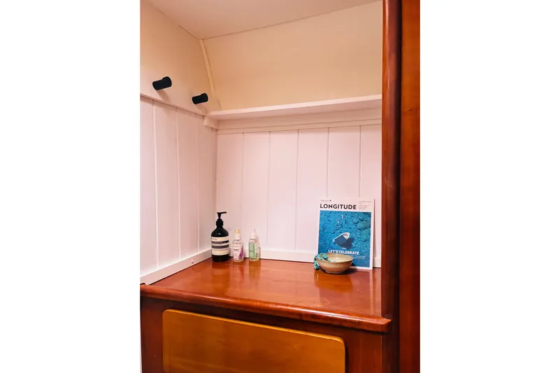 Slide: The Image of Interior of 1992 Privilege 482 yacht with wooden shelf and toiletries. - 40