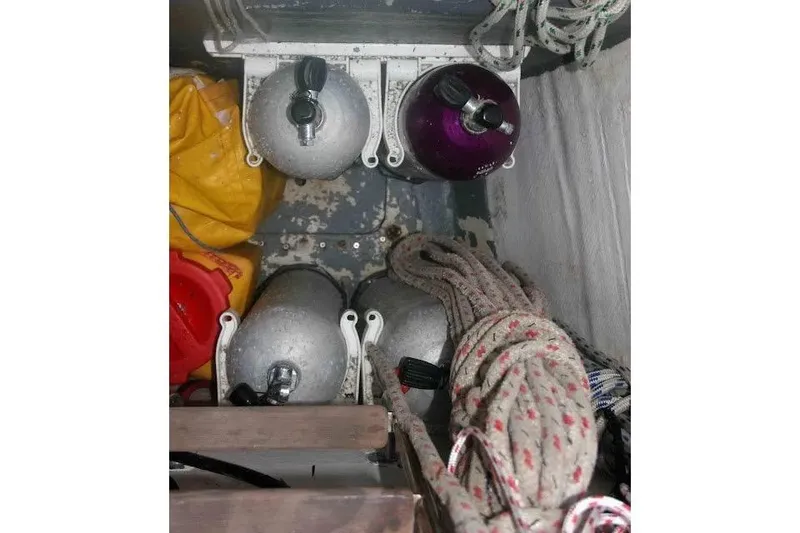 Slide: The Image of Storage compartment with scuba tanks, ropes, and gear on a 1992 Privilege 482 yacht. - 45