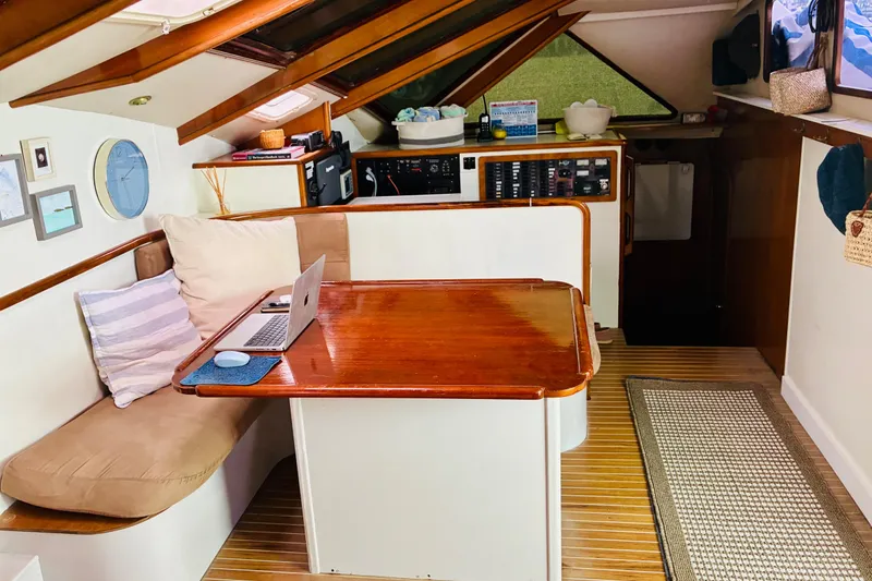 Slide: The Image of Cozy interior of 1992 Privilege 482 yacht with wooden table and seating area. - 5