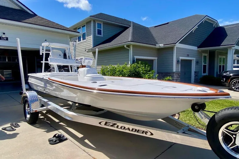 Slide: The Image of 2026 Chaos 16 Bonefish boat on trailer in residential driveway. - 0