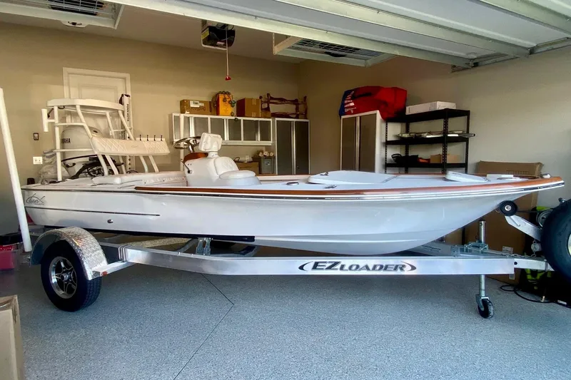Slide: The Image of 2026 Chaos 16 Bonefish boat on EZ Loader trailer in a garage setting. - 1