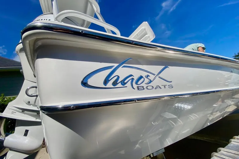 Slide: The Image of 2026 Chaos 16 Bonefish boat with sleek design and logo under clear blue sky. - 4