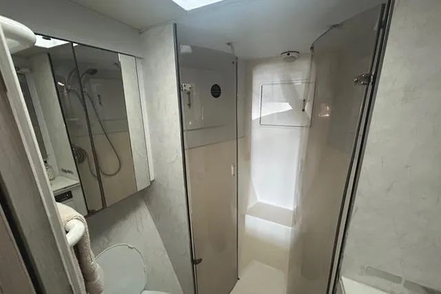 Slide: The Image of Bathroom interior of 1995 Ocean 53 Super Sport yacht, featuring shower and mirrored cabinets. - 12