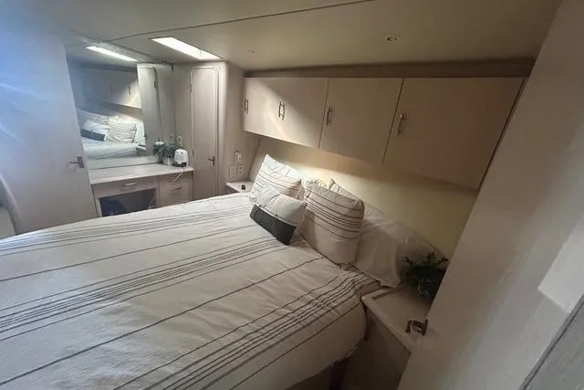 Slide: The Image of Luxurious bedroom interior of 1995 Ocean 53 Super Sport yacht with cozy bedding. - 13