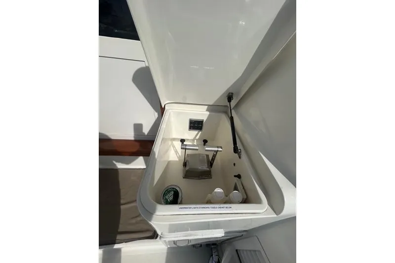 Slide: The Image of 1995 Ocean 53 Super Sport yacht storage compartment with open lid and interior view. - 16