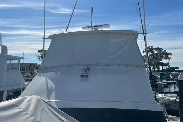 Slide: The Image of 1995 Ocean 53 Super Sport yacht docked at marina under clear blue sky. - 18