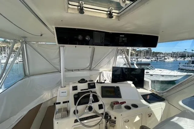 Slide: The Image of 1995 Ocean 53 Super Sport yacht cockpit with steering wheel and navigation equipment. - 19
