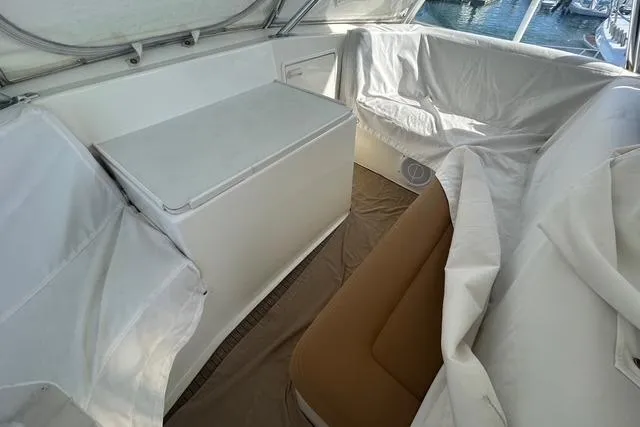 Slide: The Image of Interior of 1995 Ocean 53 Super Sport yacht with covered seating and storage. - 22