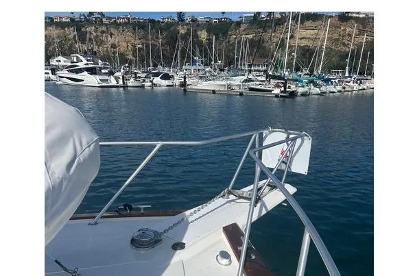 Slide: The Image of Bow view of 1995 Ocean 53 Super Sport yacht in a marina with numerous boats. - 23