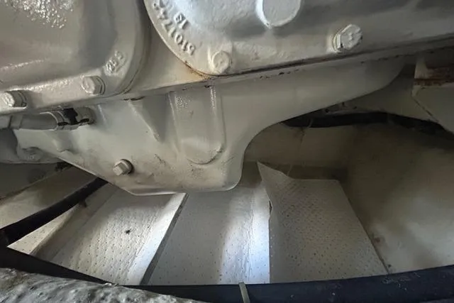 Slide: The Image of Engine compartment of a 1995 Ocean 53 Super Sport boat, showcasing mechanical details. - 28