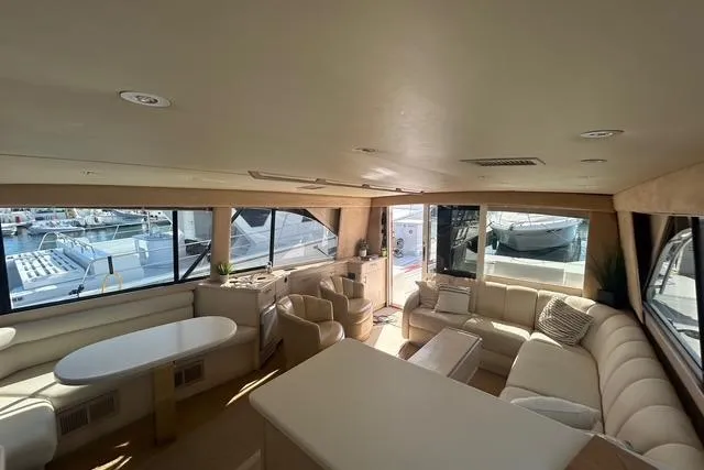 Slide: The Image of Luxurious interior of a 1995 Ocean 53 Super Sport yacht with spacious seating and large windows. - 4