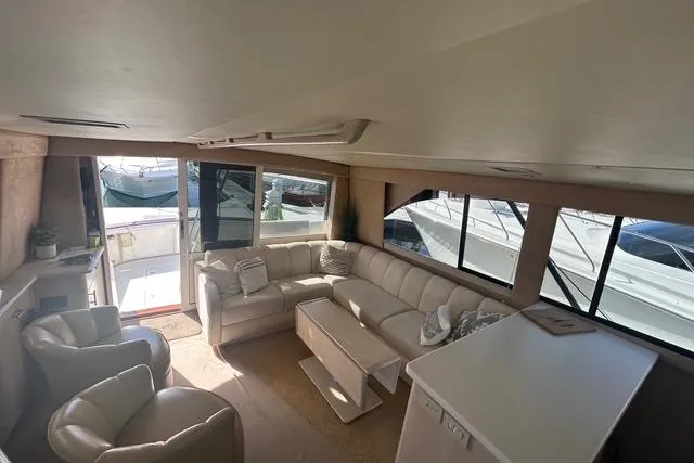 Slide: The Image of Interior of 1995 Ocean 53 Super Sport yacht with plush seating and large windows. - 7