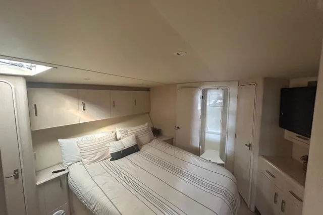 Slide: The Image of Luxurious bedroom interior of 1995 Ocean 53 Super Sport yacht with cozy bed and modern amenities. - 9