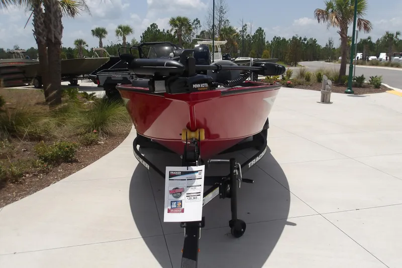 The Image of Red 2026 Tracker Super Guide V-16 SC boat on trailer, outdoor display setting. - 1