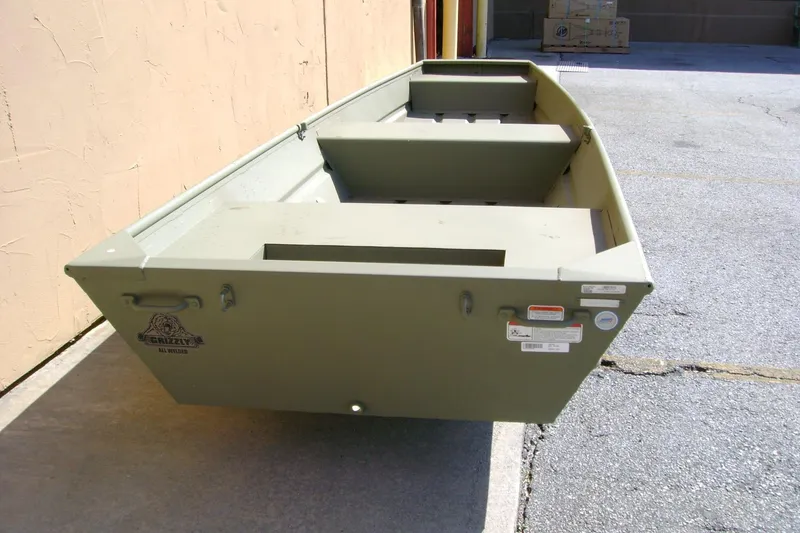 Slide: The Image of 2026 Tracker Grizzly 14 Jon boat in outdoor setting, showcasing its sturdy design. - 4