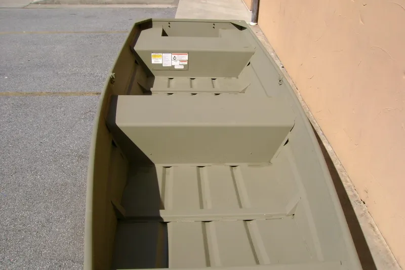 Slide: The Image of 2026 Tracker Grizzly 14 Jon boat, interior view, parked on pavement. - 5