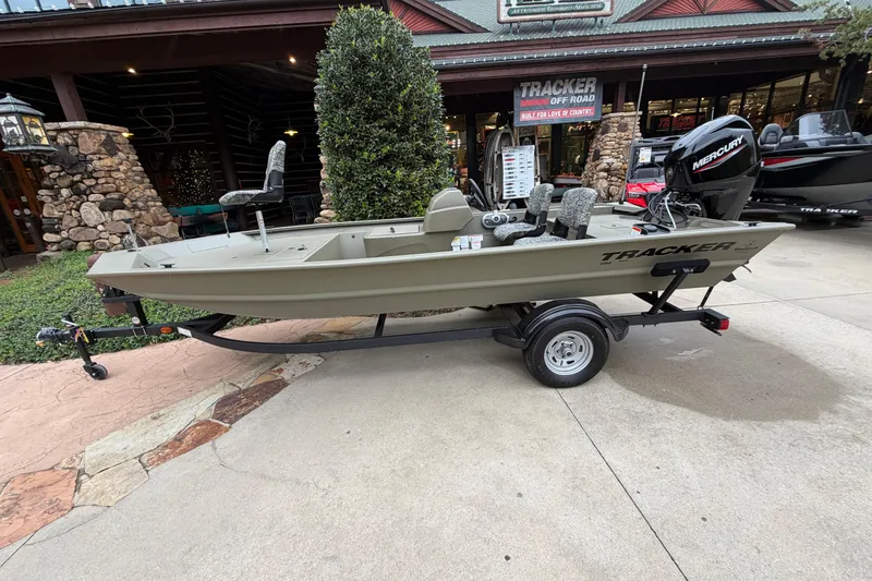 Slide: The Image of 2026 Tracker Grizzly 1754 SC boat on trailer, displayed outside a store. - 3