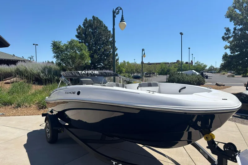 Slide: The Image of 2026 Tahoe T18 boat on trailer in sunny outdoor setting. - 1