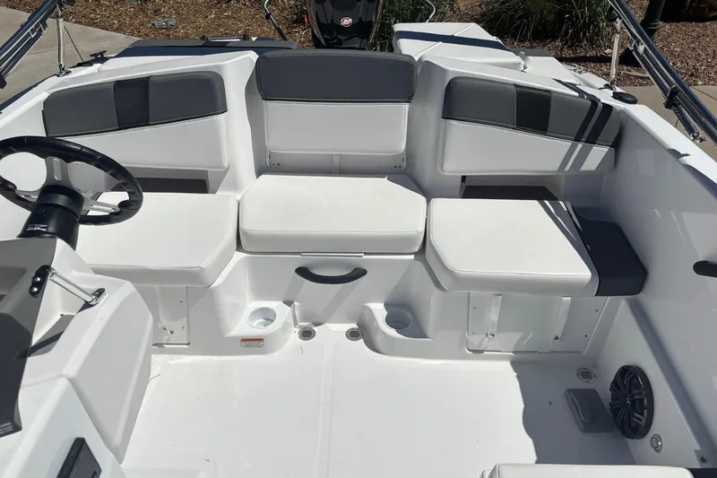 Slide: The Image of 2026 Tahoe T18 boat interior with white seating and steering wheel. - 9