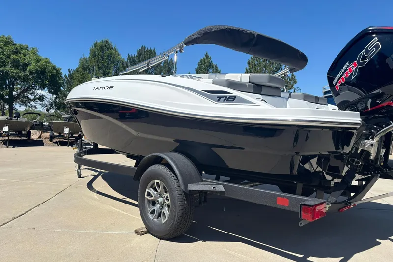 Slide: The Image of 2026 Tahoe T18 boat on trailer, featuring sleek design and powerful engine, outdoors. - 3