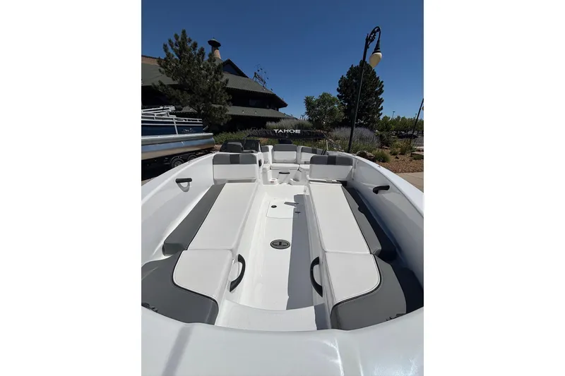 Slide: The Image of 2026 Tahoe T18 boat interior with gray and white seating, outdoor setting. - 5