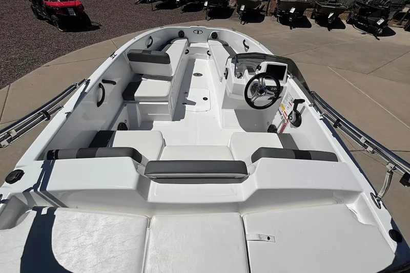 Slide: The Image of 2026 Tahoe T18 boat interior with seating and steering wheel, displayed outdoors. - 7