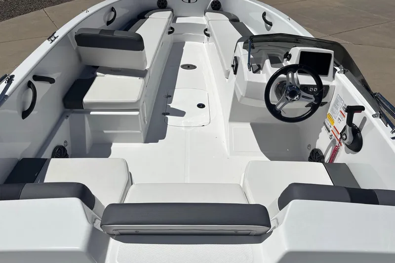 Slide: The Image of 2026 Tahoe T18 boat interior with seating, steering wheel, and dashboard controls. - 8